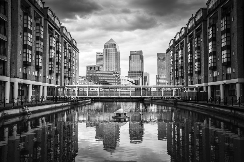 Canary-Wharf-Docklands-reflected-in-pool 
 Fabulous view of Canary Wharf reflected in a pool, with the view focussed by buildings. 
 Keywords: BW, Brunel Walk, Canary Wharf, London, Urban, stock