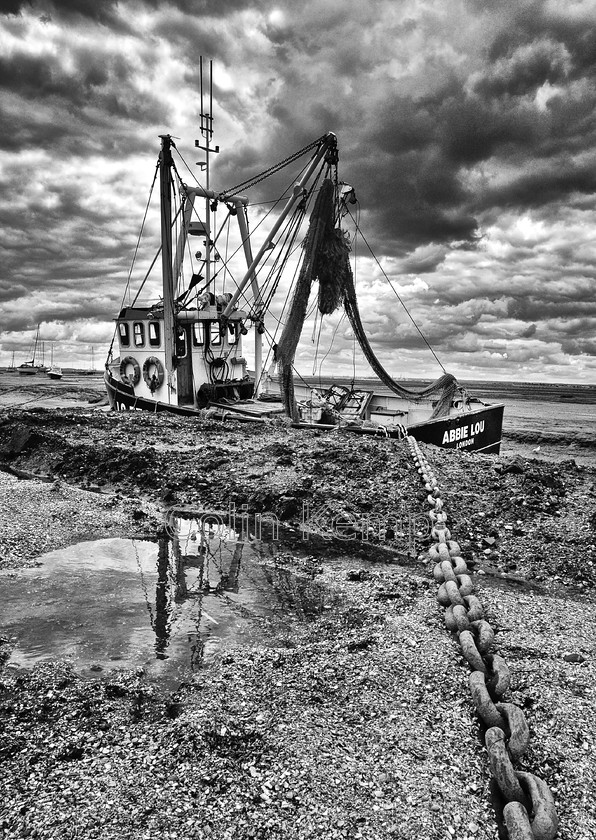 Fishing-Boat-and-Anchor-Chain-Black-and-white-photo-5844 
 Small fishing boat at anchor at low tide - Abbie Lou in Chains - a dramatic fine art black and white photograph of this cockle boat taken at Old Leigh on the Thames Estuary, Essex UK, custom sizes available. 
 Keywords: Fine art black and white print, maritime photography, Old Leigh, Thames Estuary, dramatic black and white wall decor, Abbie Lou, Cockle boat