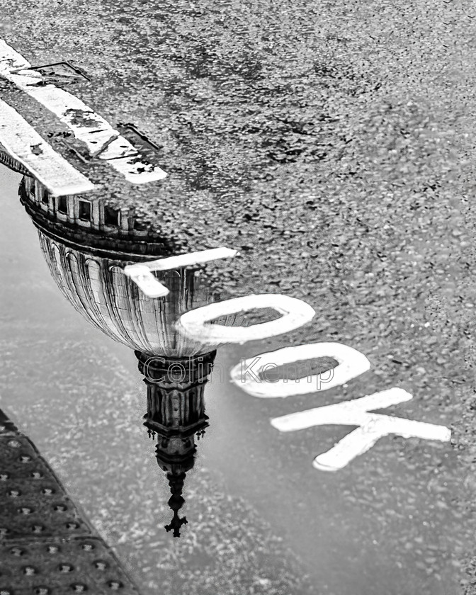 Look-St-Pauls-Reflection-0127-E5 
 Quirky London souvenir - St Paul's Cathedral dome, reflected in a puddle alongside the word LOOK - on the edge of a crosssing. Black & White souvenir print of London. 
 Keywords: London, St Pauls. reflection, Dome, London souvenir, quirky London , mono print, black and white photo, cityscape, London in the rain, Look sign