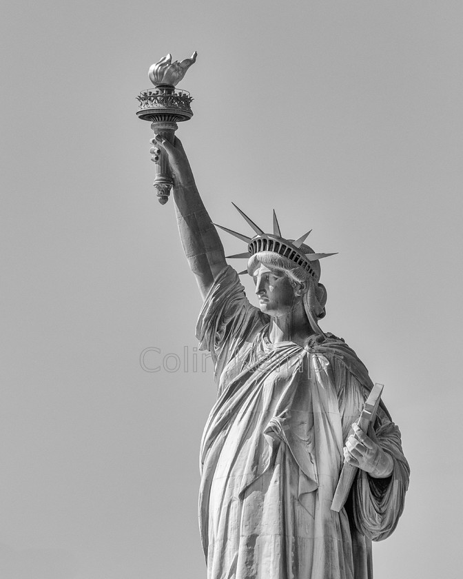 0002CK 0715-Edit 
 I lift my lamp beside the golden door. Give me your tired, your poor, your huddled masses. Statue of Liberty - black and white fine art photograph 
 Keywords: BW, New York, Statue of Liberty, USA, torch, Iconic buildings, Liberty Island, lamp